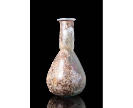 Ca. AD 100 - 200. A Roman glass unguentarum made of pale blue-green glass. It features a slightly concave base, rough pontil,
