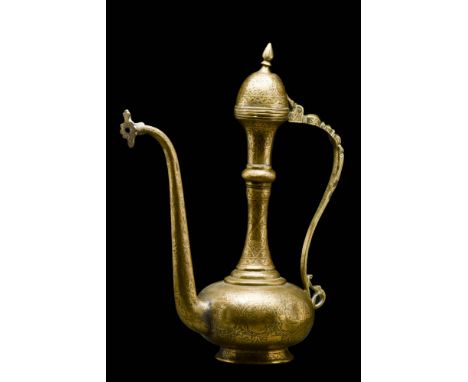 Ca. 18th century AD. A beautiful brass ewer of typical pyriform shape with an S-shaped handle and a long spout. The vessel ri