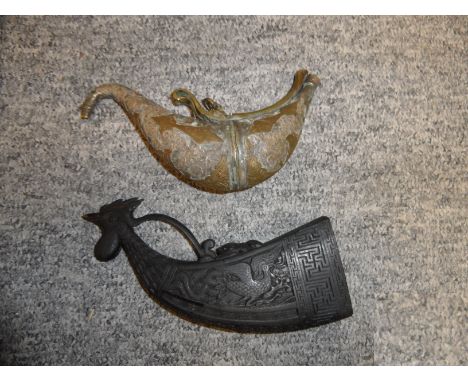 **A CARVED HARDWOOD FLASK AND AN INDIAN METAL FLASK the first of curved tapering rectangular form, carved with a bird's head 