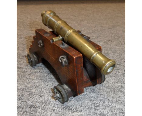 A MINIATURE BRONZE CANNON, 19TH CENTURY with bronze barrel formed in five stages, raised astragal mouldings, a pair of plain 