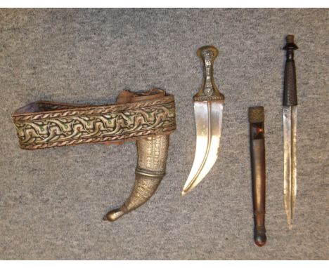 **AN AFRICAN DAGGER, PROBABLY MASAI, 19TH CENTURY AND AN ARAB DAGGER (JAMBIYA) the first with broad medially-ridged blade, ca