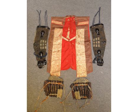 A PAIR OF JAPANESE ARM DEFENCES (KOTE), SHIN DEFENCES (SUNEATE) AND A JIMBAORI the first of quilted fabric applied with black
