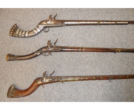 THREE AFGHAN FLINTLOCK MUSKETS (JEZAIL), 19TH CENTURY the first with octagonal swamped sighted rifled Turkish barrel, rounded