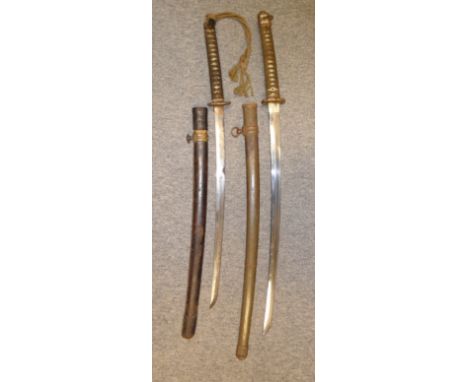 TWO JAPANESE W.W.II SWORDS (KATANA) the first with curved single-edged blade (chips, areas of pitting), plain tang pierced wi