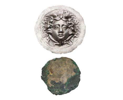 **A SILVER ROUNDEL AND A BRONZE FRAGMENT the first Roman or later, possibly 2nd century, depicting a head of Medusa in repous