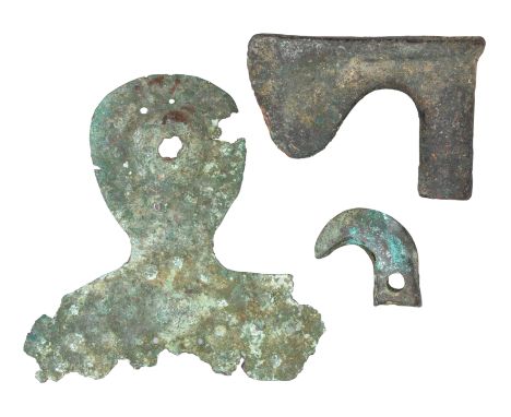 A NORTH-WEST PERSIAN BRONZE AXE-HEAD AND TWO FURTHER BRONZE ELEMENTS, 1000 B.C. in excavated condition, the first of wedge-sh