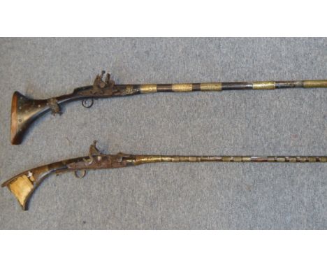 TWO MOROCCAN SNAPHAUNCE GUNS, 19TH CENTURY the first with swamped barrel retained by numerous brass bands, flat lock of chara