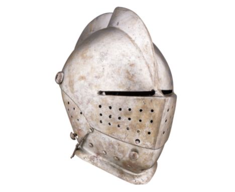 A GERMAN CLOSE HELMET FOR TOURNEY USE, CIRCA 1600 with rounded one-piece skull rising to a high, file-roped medial comb, and 