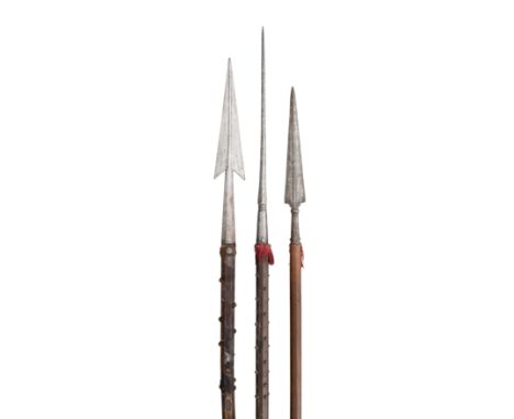 **THREE EUROPEAN SPEARS, 17TH/19TH CENTURIES the first with triangular medially-ridged head, tapering faceted socket, on a wo