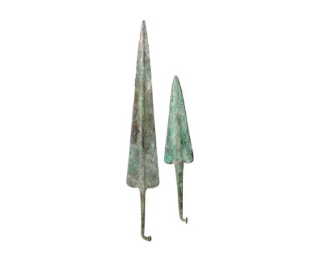 TWO NORTH-WEST PERSIAN BRONZE DAGGERS, 14TH/10TH CENTURY B.C. PROBABLY MARLIK in excavated condition, the first with tapering