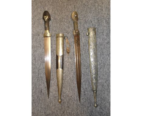 TWO CAUCASIAN DAGGERS (KINDJAL) the first with broad blade formed with an off-set fuller engraved white metal hilt, horn grip