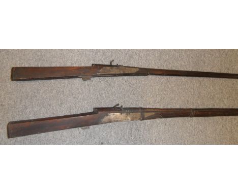 TWO INDIAN MATCHLOCK MUSKETS, 18TH/19TH CENTURIES the first large, with heavy barrel retained by three slender iron bands, in