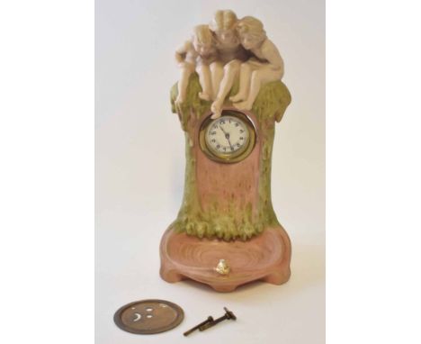 Royal Dux watch holder modelled as three cherubs sitting on a tree trunk, 30cm high 