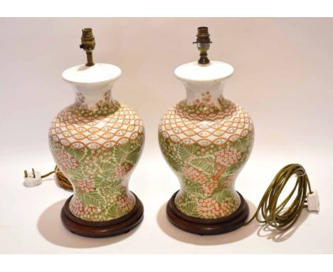 Two modern ceramic electric lamps stands of inverted baluster form and decorated throughout with foliate and blossom detail o