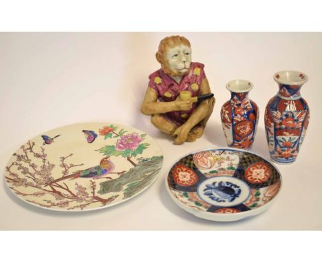 Chinese model of a monkey smoking a pipe, together with a Japanese porcelain Imari dish and further Japanese plate and two Ja