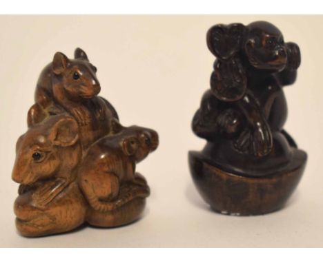 Two carved netsuke, one modelled as a monkey seated on a shell, the other as a group of three rats 