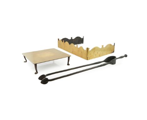 C. F. A. VOYSEY (1857-1941) FOR THOMAS ELSLEY &amp; CO. ARTS &amp; CRAFTS BRASS FIRE IRON, CIRCA 190067cm long; an ARTS &amp;