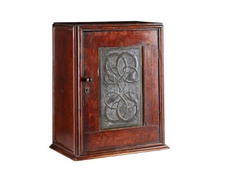 ENGLISH SCHOOL ARTS &amp; CRAFTS OAK TABLE CABINET, CIRCA 1910with single door, enclosing a shelf and set with fine repoussé 