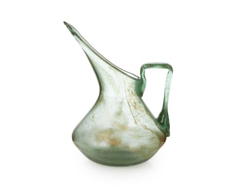 CHRISTOPHER DRESSER (1834-1904) FOR JAMES COUPER &amp; SONS, GLASGOW 'CLUTHA' GLASS PITCHER, CIRCA 1890the green glass body w