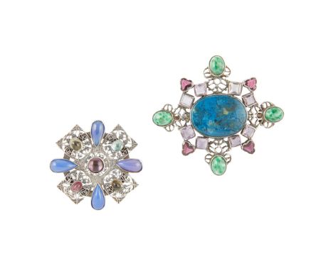 AMY SANDHEIM (FL. 1915-1939) WHITE METAL AND GEM-SET BROOCHthe cruciform panel set with coloured cabochons, cast with entwine