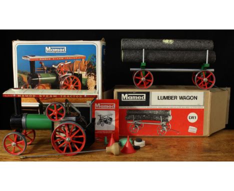 A Mamod T.E.1a live steam traction engine, green body with red and white canopy roof, single spoked red flywheel, fitted with