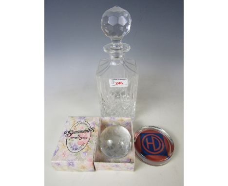 A crystal decanter together with two glass paperweights