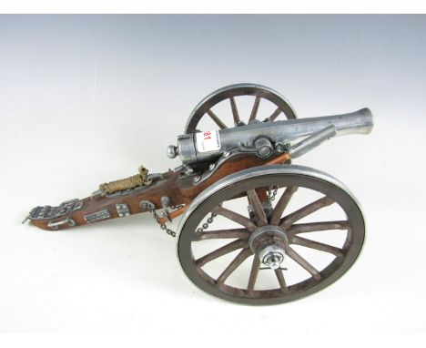 A quality cast metal and wooden scale model cannon