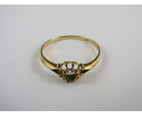 A yellow metal dress ring, stamped 18, tests as gold (stones missing), 2.3g