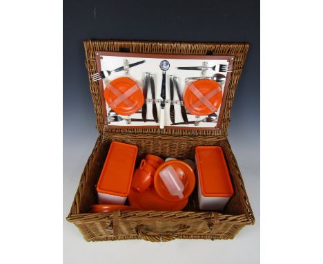 A vintage wicker picnic hamper and contents 