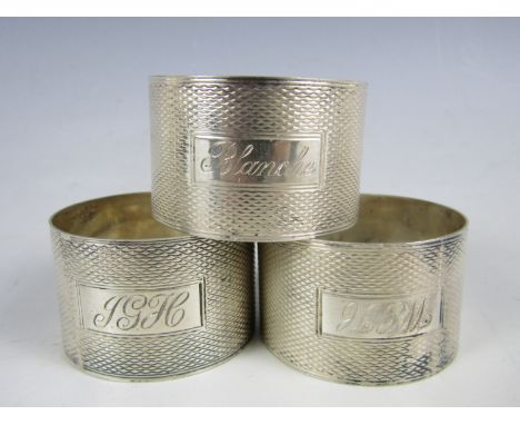 Three silver napkin rings with engine turned decoration 