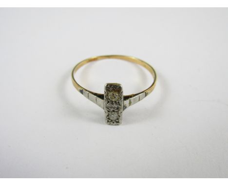 A vintage diamond dress ring, having a rectangular white-metal face, gypsy-set with two diamond brilliants each of approximat