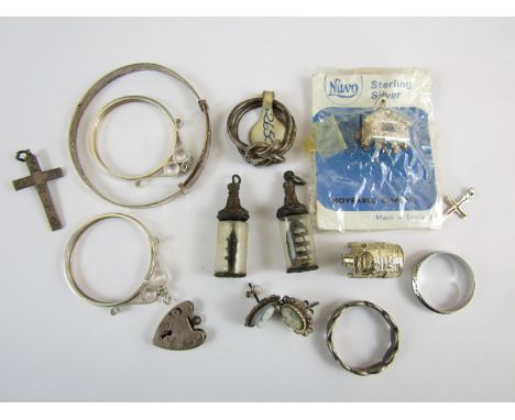 Sundry white metal jewellery and charms, stamped silver, including a baby bangle, pendant coin suspenders, rings, cruciform p