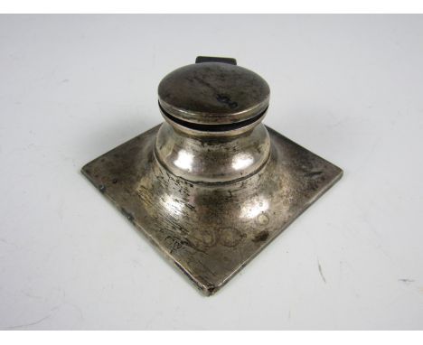 A silver capstan inkwell