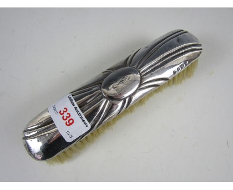 A vintage silver clothes brush 