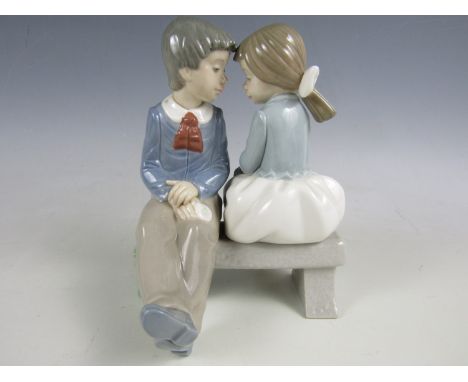 A Nao figurine of a boy and girl 