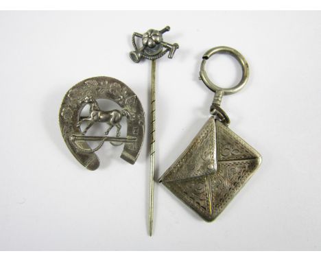 A novelty silver pendant fob stamp box together with an equestrian stick pin and a Victorian silver horseshoe brooch