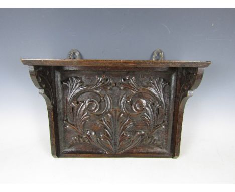 A late 19th Century carved-oak shelf bracket