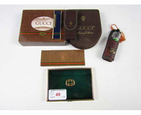 A lighter together with a card case and perfume bottle