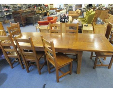 A light wood dining table with two extra leaves, 30" x 99 2/8", when extended, with eight dining chairs 