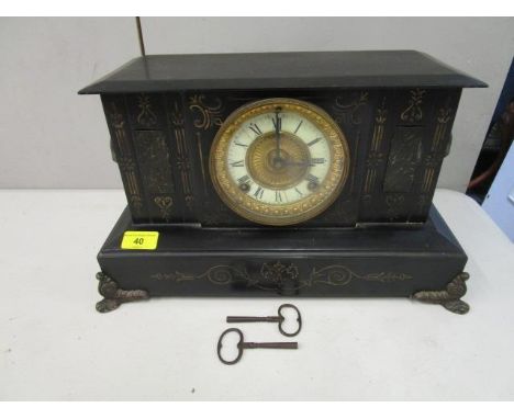 A Victorian black marble cased mantel clock, with ram mask handles, on cast feet 