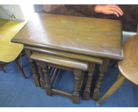 Two Ercol elm two tier lamp tables with drawers, a nest of three tables and an oak coffee table 
