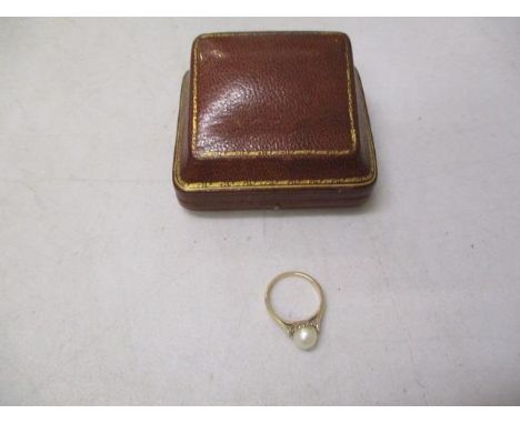 A 9ct gold ring set with a pearl in a brown leather clad box, 2g 