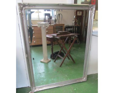 A very large rectangular bevelled edge mirror in silver coloured frame