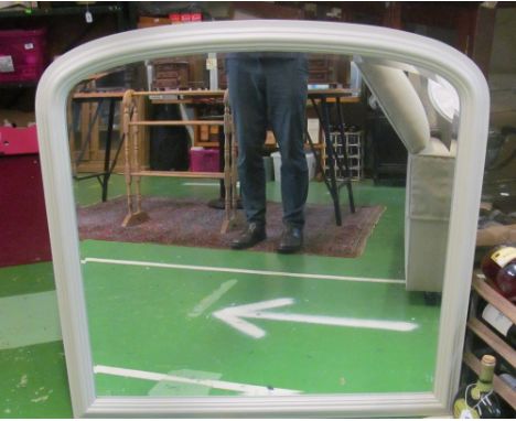 A large arched bevelled edge mirror in light grey frame