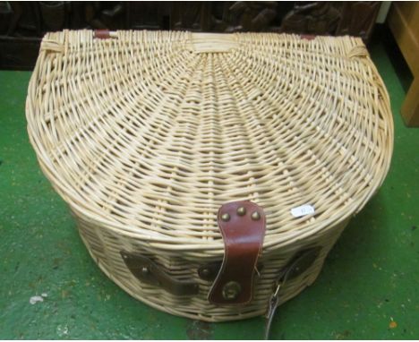 A wicker picnic hamper fitted with plates et cetera