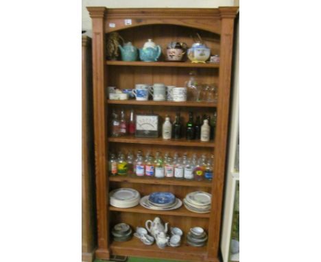 A tall pine five shelf bookcase