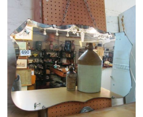 A shaped bevel edge mirror