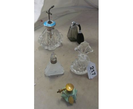 A Sterling silver and enamel topped scent bottle (a/f) and four other scent bottles