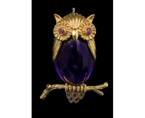 An owl brooch, the body set with a cabochon amethyst, and the eyes with circular -cut rubies modelled seated on a branch