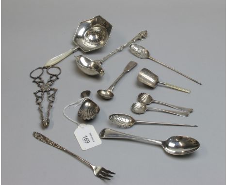 A George III silver caddy spoon of scoop form with carved mother of pearl handle, 9cm, London 1803, together with a William I